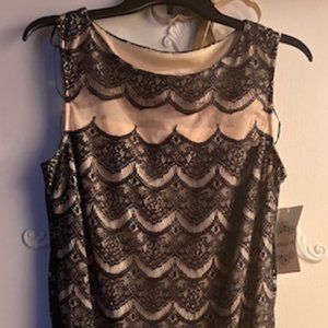 Black dress with scalloped lace hemline.